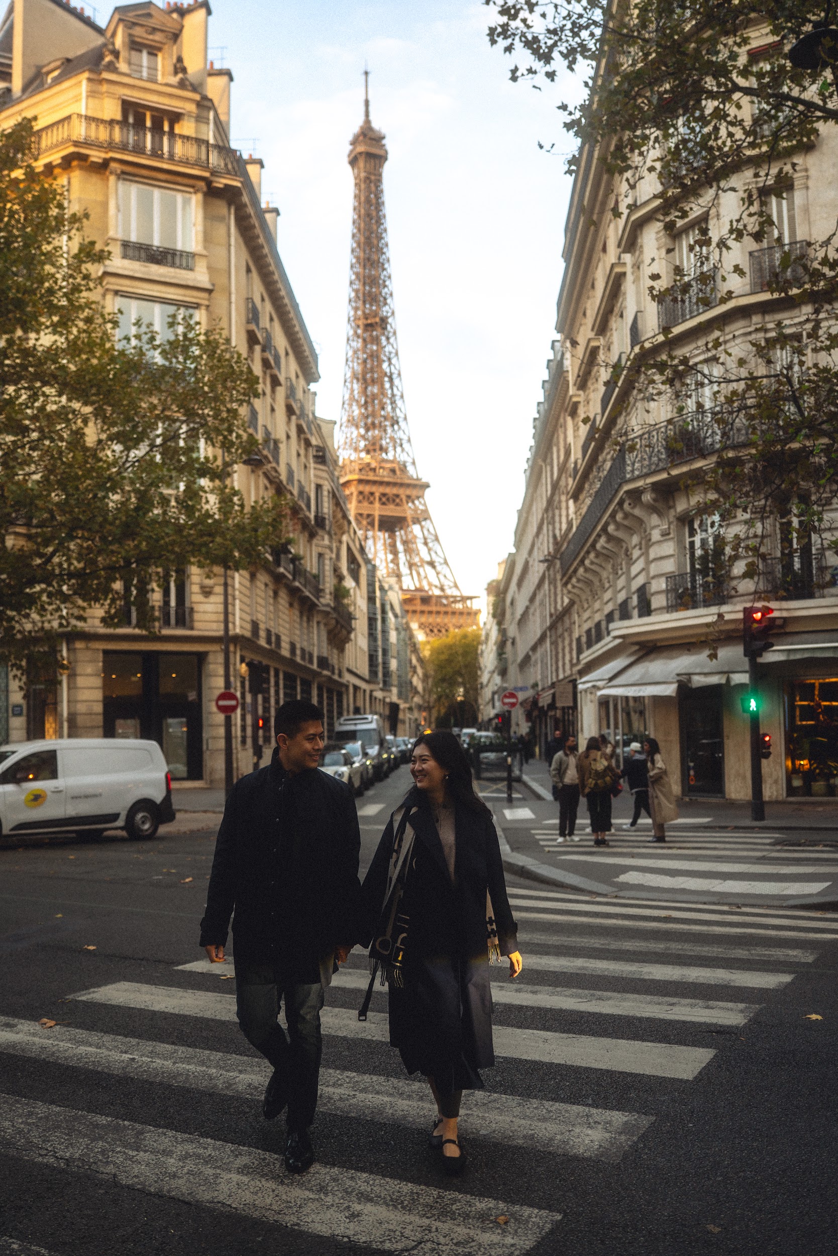 Patrick and Ivy crossing a Paris street with the Eiffel Tower behind them